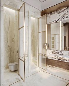 an elegant bathroom with marble walls and flooring