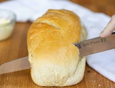 a loaf of bread being cut with a knife