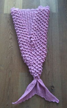 a knitted mermaid tail laying on the floor