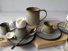 an assortment of coffee cups, saucers and spoons