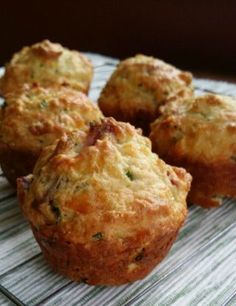 four small muffins sitting on top of a cooling rack next to each other