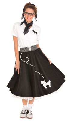 a woman wearing a black and white dress with poodles on the skirt is posing for