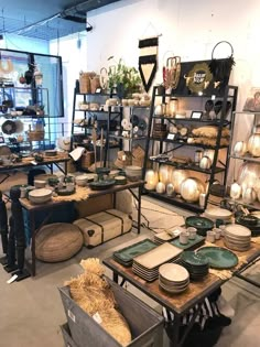 a room filled with lots of different types of plates and bowls on display next to each other