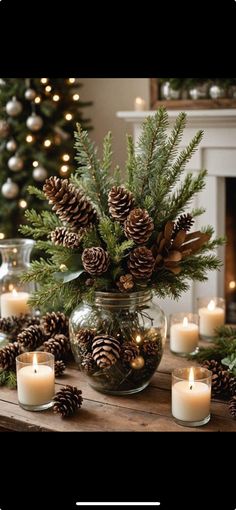 candles and pine cones in a glass bowl on a table