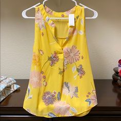 Loft Sleeveless Yellow Floral Blouse. Never Worn Yellow Floral Print Tank Top For Spring, Spring/summer Sleeveless Blouse, Summer Sleeveless Blouse For Spring, Sleeveless Summer Blouse For Spring, Summer Style Sleeveless Blouse For Spring, Sleeveless Vest Blouse For Summer, Spring Tank Blouse, Spring Cami Vest Blouse, Sleeveless Floral Print Blouse For Beach