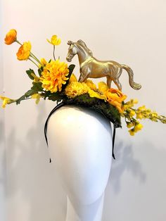 "Horse Fascinator- Day at the Races- Yellow Flower Headpiece - Mad Hatter- Kentucky Derby- Racing Fashion Hi,    This piece has a beautiful collection of yellow flowers on a faux green moss is about 6\" wide. The gold plastic horse is about 4' high.  It's placed on the top of a skinny  1/4 \" satin covered headband that fits any adult head size.   It's a little heavy so you may need a bobbie pins to hold it on.  -------------------------------------- If you like this try: https://doramarra.etsy.com/listing/1547668418 -------------------------------------------------- I ship US Postal Service. USA DOMESTIC CHOICES   (From mailed date in business days) First Class:  Arrives 3-6 days. (No insurance) Priority:        Arrives 1-3 days.  (Insurance included)                   Express:       Arri Diy Kentucky Derby Fascinator, Kentucky Derby Costume, Gold Headpiece For Spring Races, Gold Fascinator For Spring Garden Party, Gold Costume Hats And Headpieces For Races In Spring, Gold Costume Hats And Headpieces For Spring Races, Yellow Flower Hat For Spring, Yellow Flower-shaped Hats For Spring, Yellow Headpiece For Royal Ascot Races