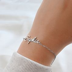 This beautiful bracelet features a custom name charm made from silver and 18k gold PVD plated stainless steel and 9 different chain types to choose from. Available in lengths of 6 to 8 inches. A lovely gift or a special treat for yourself! Font type in photos: Amelia: Font 2 Sophia: Font 1 Material: Stainless Steel Chain Types: Figaro                         Rolo (2mm)                         Medium Paperclip (3.5x12mm)                         Curb (2 mm)                         Satellite Customized Minimalist Metal Jewelry, Everyday Customized Stainless Steel Jewelry, Personalized Adjustable Metal Chain Bracelet, Minimalist Custom Name Metal Jewelry, Minimalist Stainless Steel Name Jewelry, Personalized Adjustable Metal Name Bracelet, Elegant Hypoallergenic Nameplate Bracelet, Classic Personalized Stainless Steel Chain Bracelet, Metal Name Bracelet For Personalized Gift