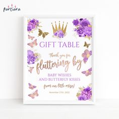 a purple and gold baby shower gift table sign with flowers, butterflies and a crown on it