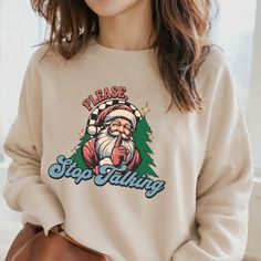 🎄Embrace the holiday spirit with a dash of humor in our “Please, Stop Talking!” sweatshirt! Featuring a trendy Santa shushing, this playful design in vibrant red, blue, and green colors is perfect for anyone who loves to add a little fun to their festive wardrobe. 🎅 Crafted from ultra-soft, high-quality fabric, this sweatshirt ensures all-day comfort whether you’re at holiday parties, cozy family gatherings, or lounging at home. The witty slogan is sure to get some laughs and make it clear tha Casual Graphic Print Holiday Sweatshirt, Casual Graphic Print Sweatshirt For Holiday, Casual Holiday Sweater With Graphic Print, Casual Holiday Sweatshirt With Graphic Print, Funny Holiday, Holiday Humor, Please Stop, Sweatshirt Christmas, Stop Talking