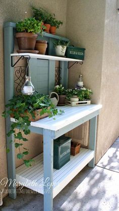 an outdoor potting bench with plants on top