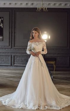 a woman in a white wedding dress holding a bouquet