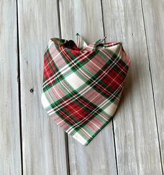 a red and green plaid bandana laying on top of a wooden floor