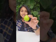 a woman holding an apple in her right hand