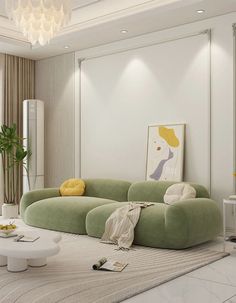 a large white couch sitting in a living room under a chandelier