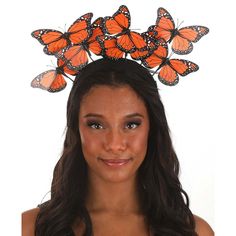 a woman wearing a tiara with orange butterflies on her head