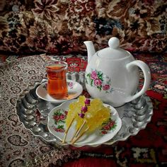 a tea pot and two plates with food on them