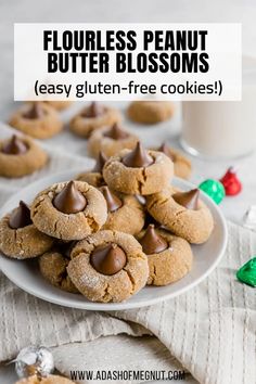 a plate full of cookies with chocolate chips and candy on the side, next to a glass of milk