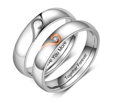 two wedding rings with the words love you more engraved on each ring and one diamond in the middle