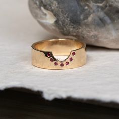 A beautiful and utterly unique 'cut out' band with rubies studded along the curve. It is possible to customize this ring, please get in touch if you have a ring you would like it to fit with, or you have an idea to explore. ENGRAVING is available for this ring. Please see the following link and add to your basket: Engraving DETAILS Available in 9ct Yellow Gold, 9ct White Gold, 9ct Rose Gold, 14ct Yellow Gold, 18ct Yellow Gold, 18ct White Gold, 18ct Rose Gold All raw materials/gemstones are ethic Ruby Band Ring, Ruby Wedding Band, Ruby Wedding, Bespoke Rings, Ruby Engagement Ring, Wedding Ring Designs, Personalized Rings, Ruby Ring, Timeless Pieces