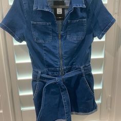 Adorable Denim Shorts Romper! Has Some Stretch To The Fabric And A Zipper Up The Front. This Is A Size Large But Runs Very Small! It Fits Like A Small. I Wear A Small And Had To Size Up To A Large But Felt That Shorts Were Still Too Short For My Comfort. (And Age! Lol) Super Cute Though For Someone Comfortable With Shorts On The Shorter Side!! Blue Denim Short Sleeve Jumpsuit, Blue Denim Jumpsuit With Short Sleeves, Blue Short Sleeve Denim Jumpsuit, Trendy Short Denim Jumpsuit With Pockets, Casual Short Denim Jumpsuit, Casual Short-length Denim Jumpsuit, Casual Short Denim Jumpsuit With Pockets, Casual Mid-rise Denim Jumpsuit For Summer, Casual Mid-rise Summer Denim Jumpsuit