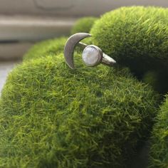 a ring is sitting on top of some moss