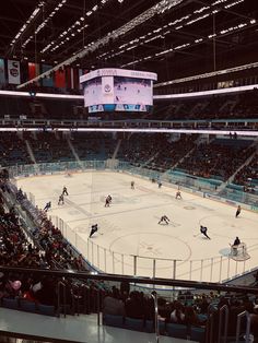 an ice hockey game is being played in a large arena