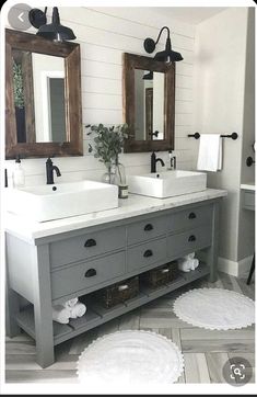 a bathroom with two sinks, mirrors and rugs on the floor in front of them