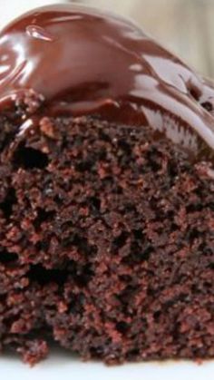 a close up of a piece of cake with chocolate frosting on it's surface