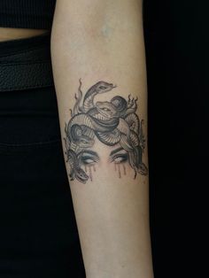 a woman with a snake tattoo on her arm