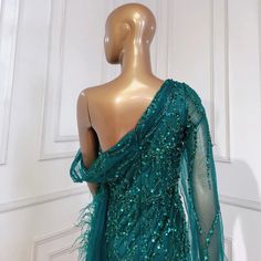 Mesmerizing Turquoise Hue: Radiates vibrance and charm, perfect for making a statement. Mermaid Silhouette: Accentuates curves gracefully, offering a flattering fit. Overskirt Detail: Adds drama and flair to the gown, creating an eye-catching look. Luxurious Beaded Embellishments: Enhances the gown's elegance and adds a touch of sparkle. High-Quality Craftsmanship: Expertly crafted for comfort, durability, and a flawless finish. Versatile Wear: Suitable for various occasions, including weddings, Vintage Beaded Prom Dress, Prom Dance, Formal Parties, Water Blue, Beaded Prom Dress, Mermaid Silhouette, Mermaid Evening Dresses, Pink Turquoise, Ladies Party