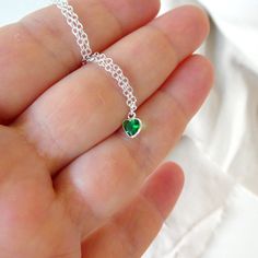 "Sterling Silver necklace with zircon emerald. Size shown is 16\". Please choose your favorite necklace length at checkout. All lengths have a one inch extender, that way you'll have some wiggle room to play with the length. For example, if you choose a 14 inches necklace length, you'll have options to close the necklace at any length between 14 inches and 15 inches. ⇒ MATERIALS Entirely made of .925 sterling silver and a zircon. ⇒ LENGTH Available in several lengths at checkout. Kindly choose y Heart Cut Emerald Necklace For Gift, Emerald Heart Charm Jewelry, Green Heart-shaped Jewelry Gift For Her, Heart Shaped Emerald Necklace As A Gift, Heart-shaped Emerald Necklaces As A Gift, Heart-shaped Emerald Necklace As A Gift, Heart-shaped Emerald Jewelry With Birthstone, Heart-shaped Emerald Necklace For Gift, Heart-shaped Emerald Birthstone Jewelry