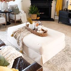 a living room filled with furniture and a fire place in the middle of the room