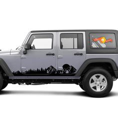 a gray jeep with mountains and trees painted on it's side, parked in front of a white background