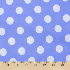 a ruler is next to a blue and white polka dot fabric