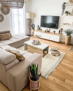 a living room filled with furniture and a flat screen tv on top of a wooden floor