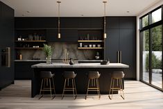 a modern kitchen with black cabinets and marble counter tops, gold accents and bar stools