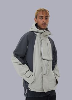 Experience the perfect blend of tactical techwear and contemporary fashion with this stylish streetwear jacket. Envision yourself navigating the bustling cityscape, a beacon of confidence and sophistication in an ever-changing world. Amid the urban jungle, you remain unruffled, undeterred by the elements, and prepared for anything life throws your way. The key to your unwavering self-assurance? The Streetwear Windbreaker. This urban streetwear jacket is the epitome of modern fashion and meets functionality, meticulously designed for the discerning city dweller. A fusion of tactical techwear and cutting-edge style, this mid-length utility vest will undoubtedly set you apart from the crowd. As you traverse the city, the two large front pockets keep your essentials securely within reach, offe Urban Long Sleeve Parka, Urban Windbreaker With Detachable Hood For Urban Adventures, Urban Parka With Detachable Hood For Streetwear, Urban Outerwear With Detachable Hood For Streetwear, Functional Streetwear Outerwear With Multiple Pockets, Urban Utility Jacket With Detachable Hood For Streetwear, Urban Windproof Outerwear For Streetwear, Urban Outerwear With Multiple Pockets, Modern Long Sleeve Windbreaker For Streetwear