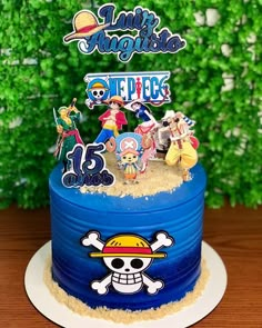 a birthday cake decorated with cartoon characters on it's top and bottom tiers