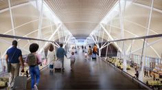 people are walking through an airport with their luggage