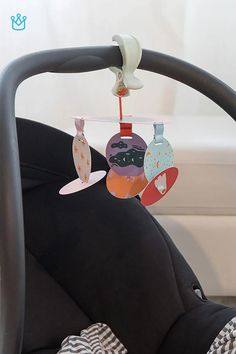 a baby crib with toys hanging from it