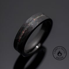 a wedding band with black ceramic and multicolored glitters