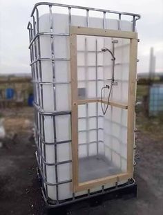 a large white container sitting on top of a dirt field