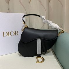 The iconic Saddle bag is reinvented once more by Maria Grazia Chiuri. Featuring a Saddle flap with a magnetic 'D' stirrup clasp, it boasts a 'CD' signature on each side of the handle. The black grained calfskin style is embellished with antique gold-finish metal hardware. The Saddle bag may be carried by hand or over the shoulder and can be customized with different shoulder straps. Magnetic 'D' stirrup closure 'CD' signature on the strap Interior pocket Back pocket Dust bag included Made in Italy Christian Dior Saddle Bag, Dior Saddle, Maria Grazia Chiuri, Maria Grazia, Handbag Wallet, Stirrups, Wallet Accessories, Saddle Bag, Diaper Backpack