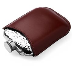 a brown leather flask with silver accents