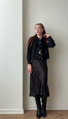 Monochromatic black outfit idea 🖤 Workwear/office appropriate. I’m wearing a black cardigan, black silk midi skirt, black belt, and tall black boots.