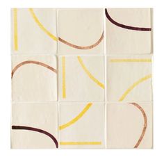 an abstract tile design with yellow and brown lines on it's sides, in squares