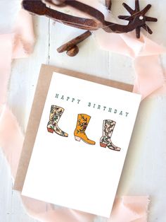 a birthday card with three cowboy boots on it