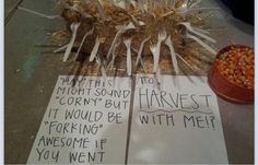 two paper signs with writing on them sitting next to a bowl of corn kernels