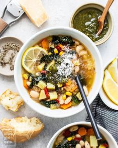 two bowls filled with soup next to bread and lemon slices