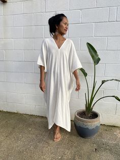 ITEM DETAIL * Bust / Waist / Hips up to 68 in. * Arms open up to 22 in. * Length 42 in. * V-Neck * Side slits * No pocket * Slipover style * All above measurement are flat FABRIC * 100% Double Gauze Cotton FIT * One size fit most up to size US 4 XL * Hangs loose and away from the body * Length can be versatile as a knee length, mid calf length, ankle length and floor length depending on your style MODEL * Height 5 ft. 4 in. / 163 cm. * With or without 4 in. High Heels CARE * Hand washing recomme Flowy Beige Kaftan For The Beach, White Relaxed Fit Maxi Dress For Loungewear, White V-neck Maxi Dress For Loungewear, Flowy Beige Kaftan For Summer, Beige Flowy Kaftan For Summer, Summer Beige Flowy Kaftan, Relaxed Fit V-neck Tunic For Beach Season, Relaxed Fit V-neck Beach Dress For Vacation, Cream Kaftan For Spring Vacation